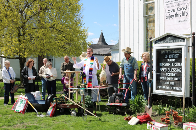 First Congregational Church Pastor Dave Forsberg blesses seeds and garden tools brought by people and prays for a good harvest during the congregation’s 2019 Good Earth Day event focusing on agriculture and the backyard gardener