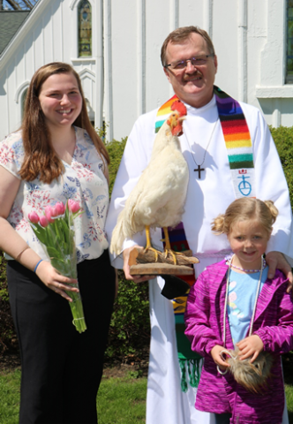 From left to right, Almont native and MSU student Ashley Gibbs, First Congregational Church Pastor Dave Forsberg and Blakely Smith following the blessing of seeds and garden tools during the congregation’s inagural 2019 Good Earth Day event focusing 